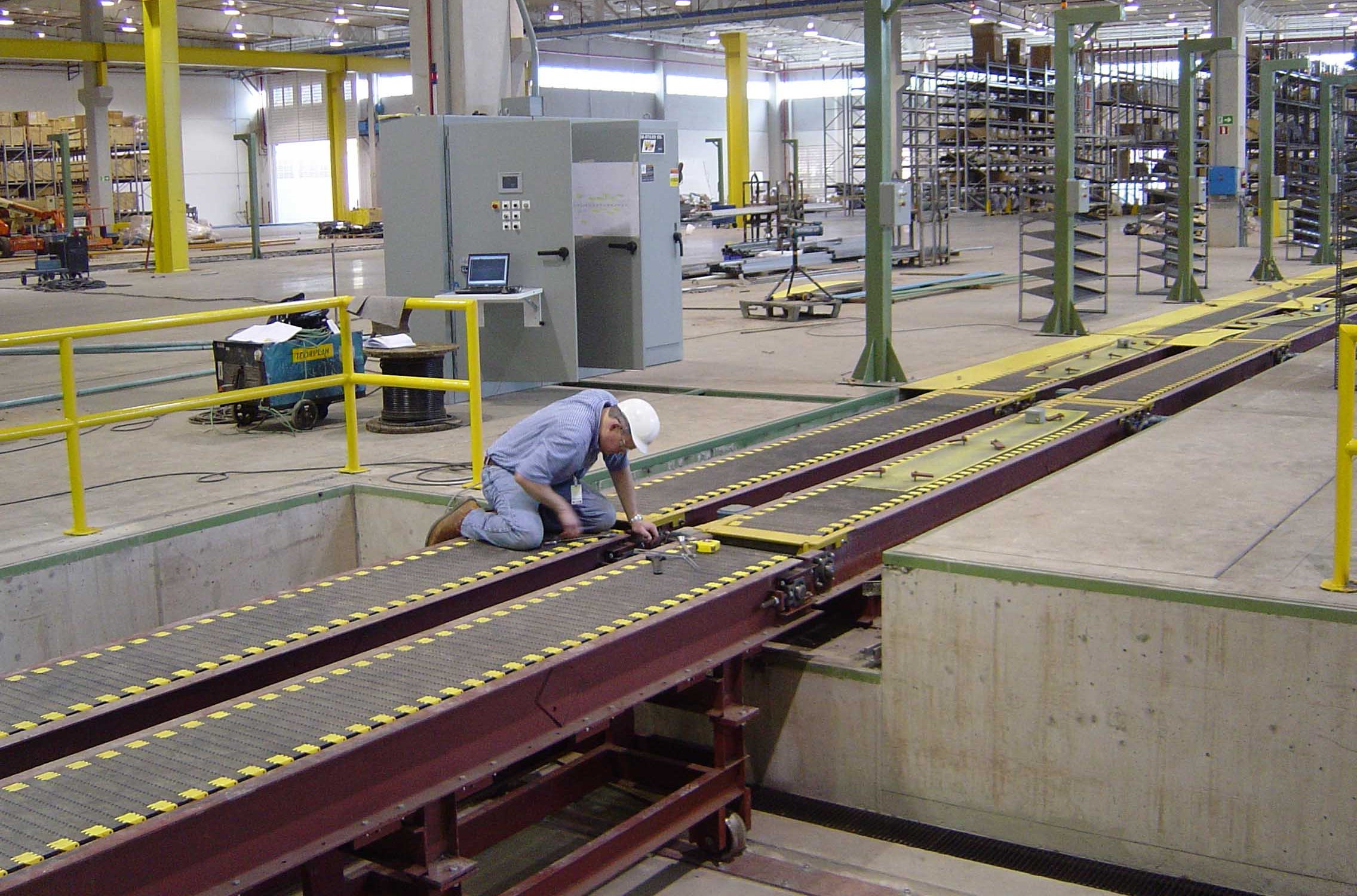 Webb-Stiles technician installing a custom conveyor system at a customer facility