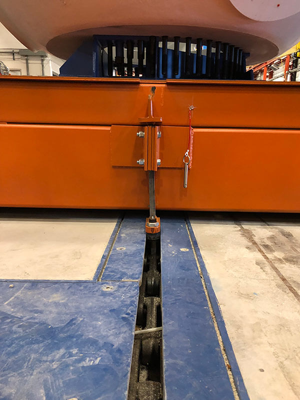 Close-up of in-floor towline conveyor center guide and drive dog from Webb-Stiles