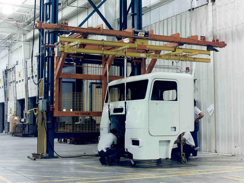 Webb-Stiles vertical lift conveyor transferring truck cab in a manufacturing facility