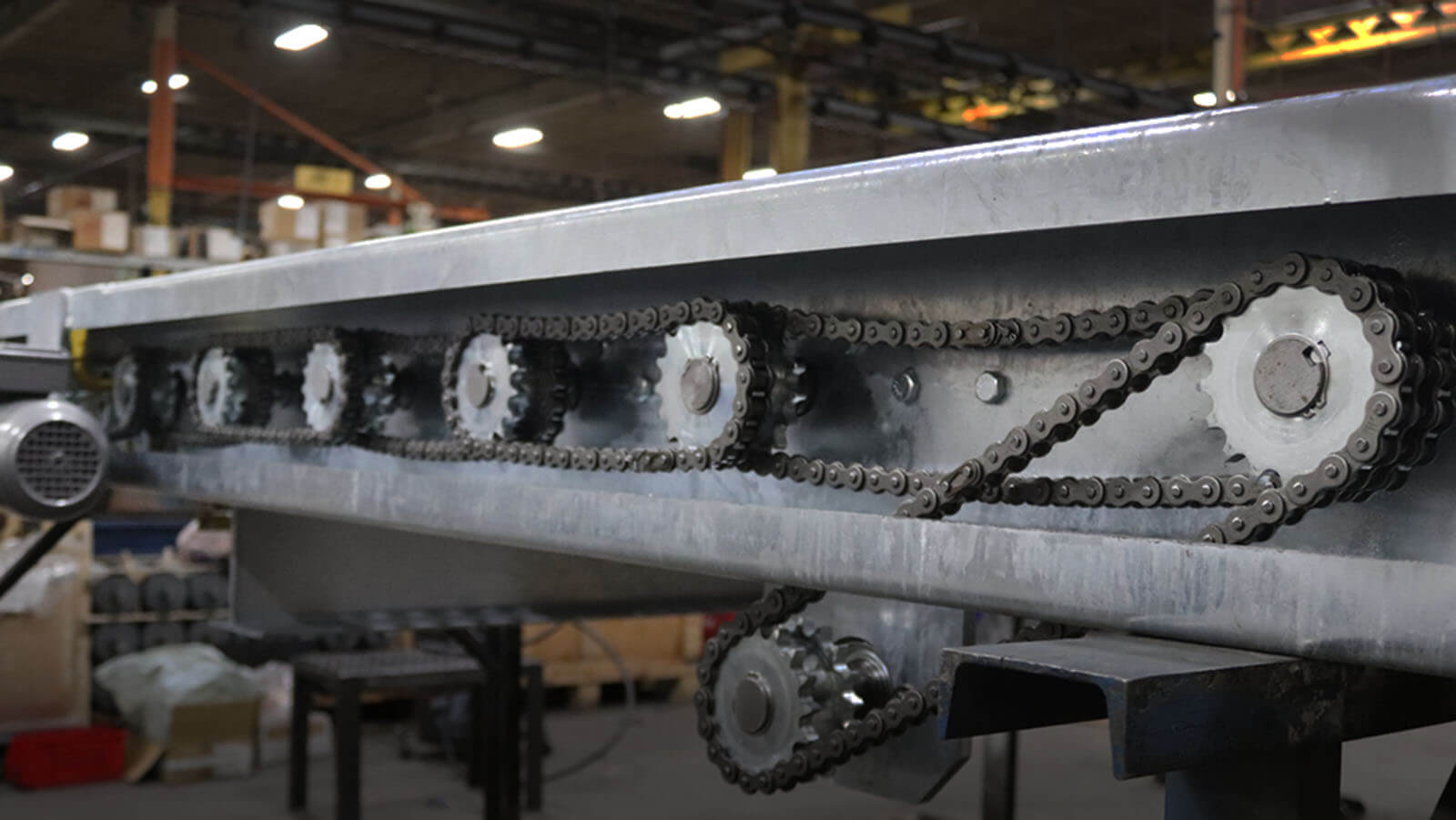 Chain Driven Live Roller Conveyor – Close-up of Drive System Chain Driven Live Roller Conveyor with dual chain loops and powered sprockets built by Webb-Stiles