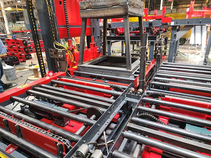 Custom hopper transport conveyor system with heavy-duty CDLR rollers and chain transfer mechanism for precise hopper positioning