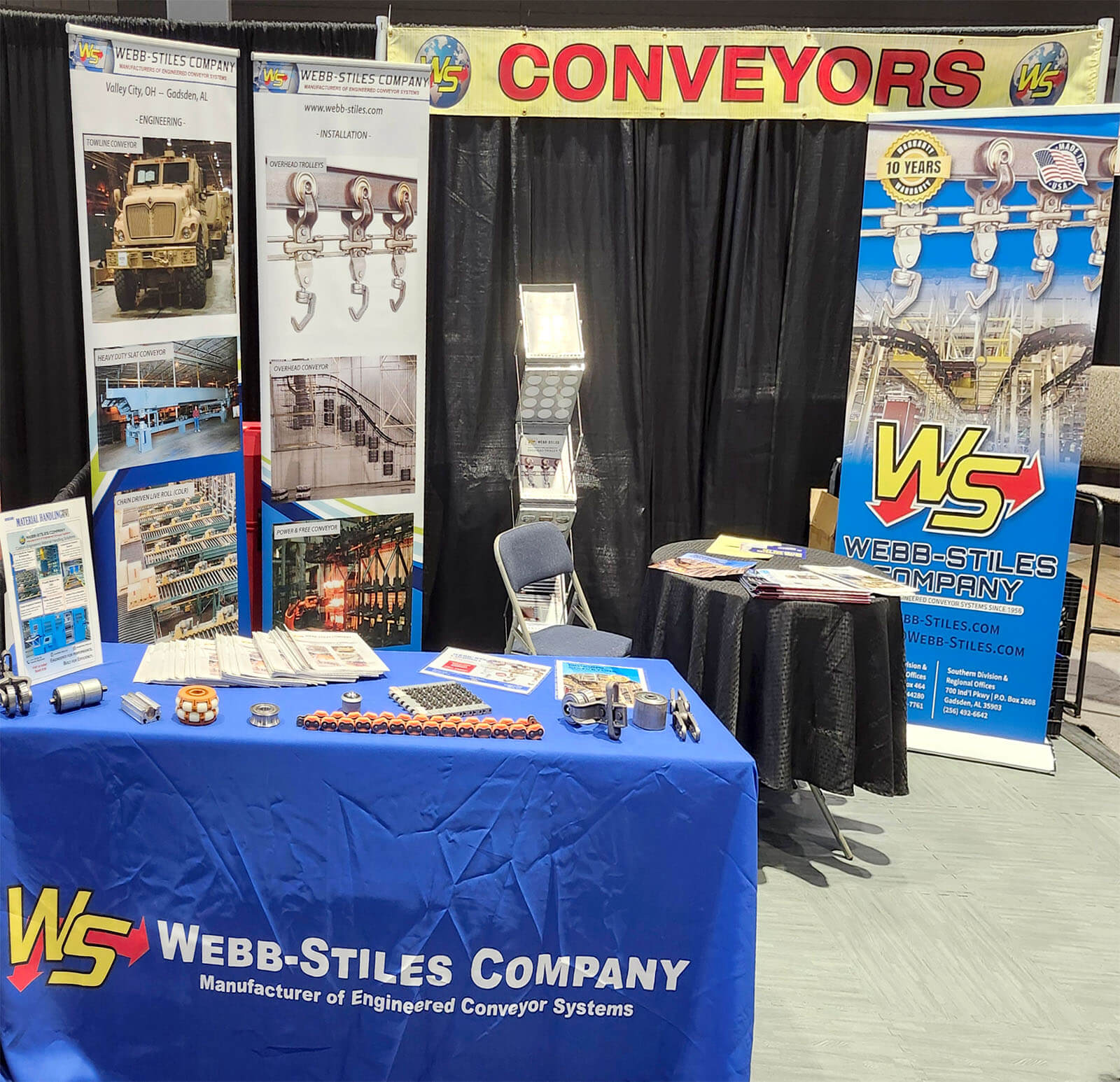 Webb-Stiles booth at Promat 2025 featuring custom conveyor components, product brochures, and vertical banners highlighting engineering, installation, and manufacturing