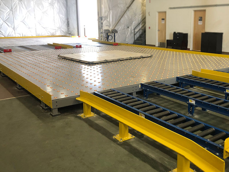 Pallet roller system with integrated ball transfer table and gravity conveyor sections