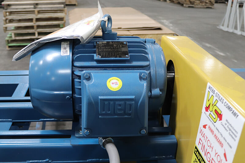 Electric motor and gearbox mounted on overhead conveyor drive system