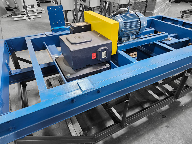 Angled view of a Webb-Stiles Caterpillar Drive assembly with motor and reducer mounted in a blue frame.